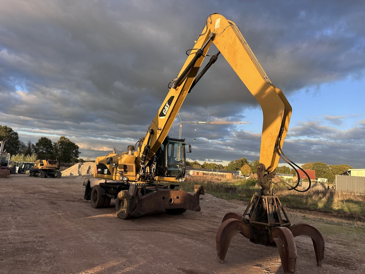 CATERPILLAR M 318 MH mit Greifer Kein 3022 3026 320 322 - حفار ذو عجلات: صورة 2 CATERPILLAR M 318 MH mit Greifer Kein 3022 3026 320 322 - حفار ذو عجلات: صورة 2