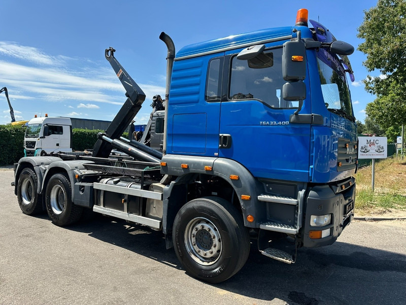 MAN TGA 33.400 6X4 HOOKLIFT AJK NHS20-4930mm - WB 3m60 - MANUAL ZF - STEEL SPRING / BLATT - BIG AXLES / AP ACHSEN - شاحنة برافعة خطافية: صورة 1 MAN TGA 33.400 6X4 HOOKLIFT AJK NHS20-4930mm - WB 3m60 - MANUAL ZF - STEEL SPRING / BLATT - BIG AXLES / AP ACHSEN - شاحنة برافعة خطافية: صورة 1
