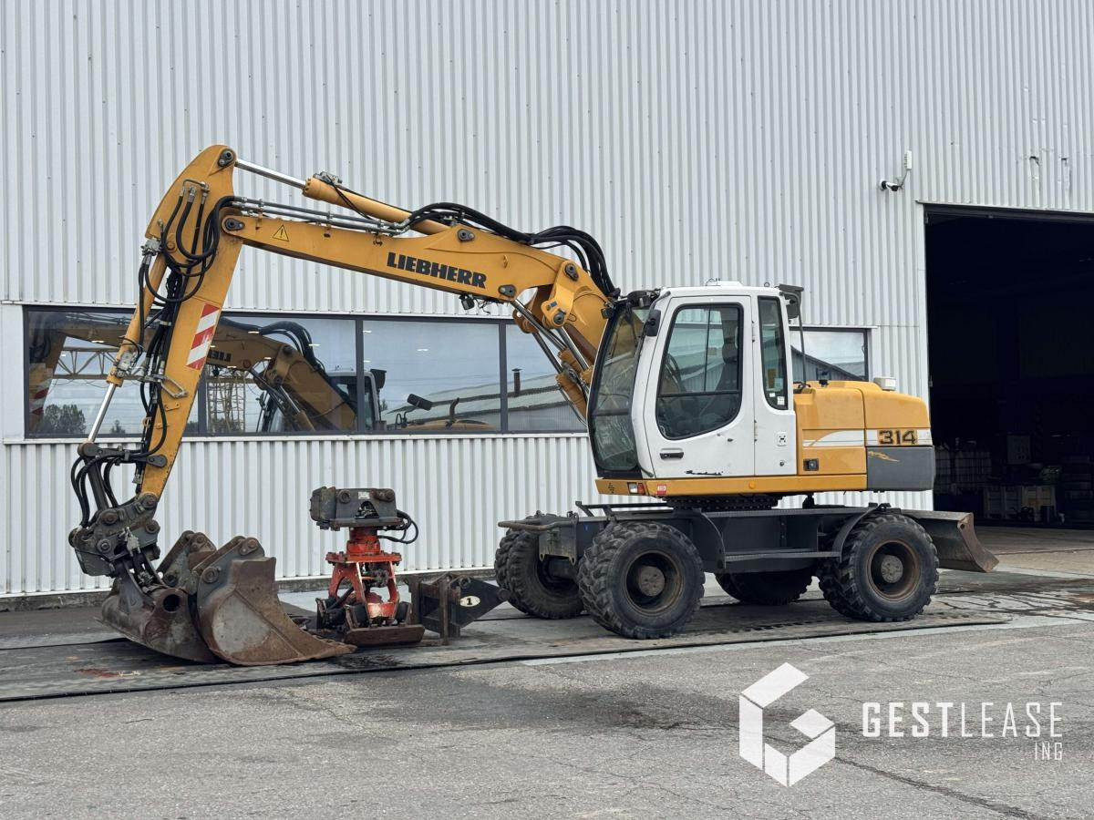 Liebherr A314 Litronic - حفار ذو عجلات: صورة 1 Liebherr A314 Litronic - حفار ذو عجلات: صورة 1