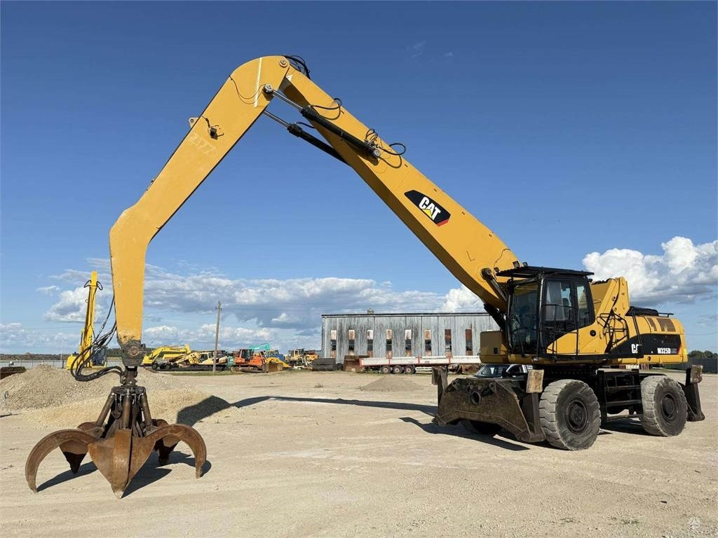 CAT M 325 DLMH - حفار ذو عجلات: صورة 1 CAT M 325 DLMH - حفار ذو عجلات: صورة 1