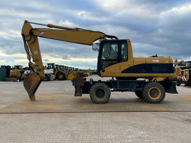Caterpillar M318C - حفار ذو عجلات: صورة 1 Caterpillar M318C - حفار ذو عجلات: صورة 1