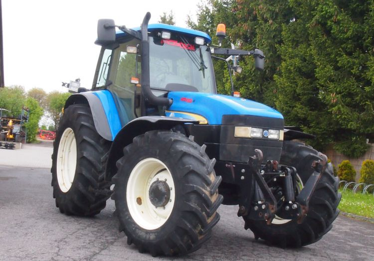 Ciągnik New Holland TM 140 2004 Przedni TUZ - جرار: صورة 2 Ciągnik New Holland TM 140 2004 Przedni TUZ - جرار: صورة 2