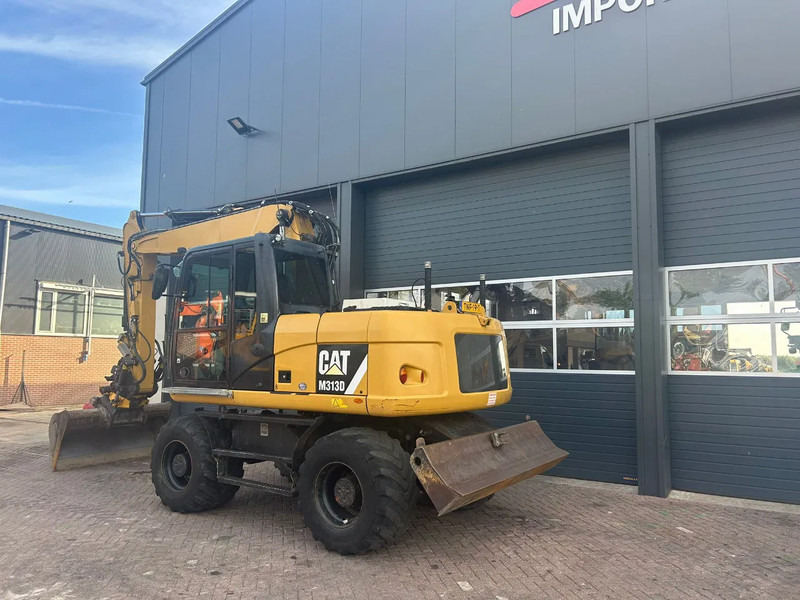 Caterpillar M313D - حفار ذو عجلات: صورة 2 Caterpillar M313D - حفار ذو عجلات: صورة 2