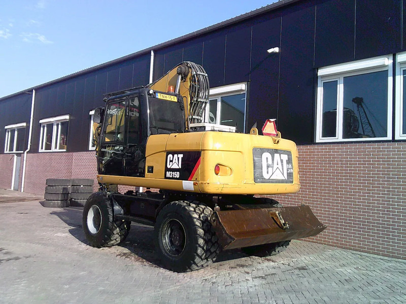Caterpillar M315D - حفار ذو عجلات: صورة 2 Caterpillar M315D - حفار ذو عجلات: صورة 2