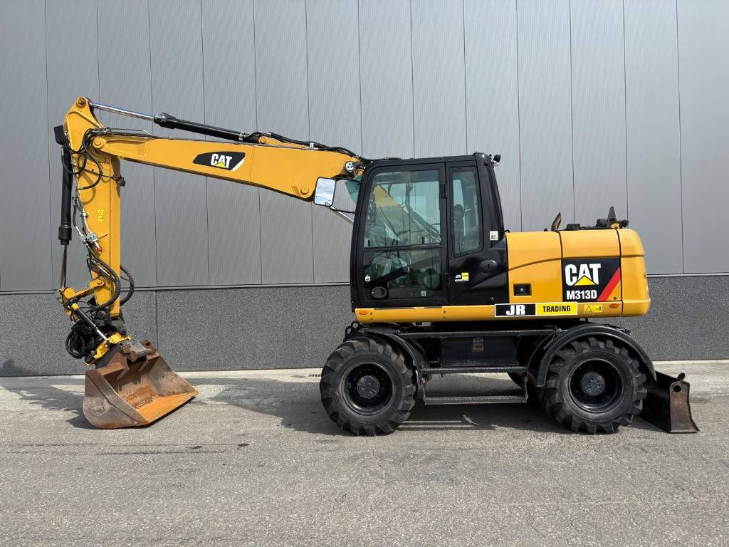 CAT M 313 D - حفار ذو عجلات: صورة 1 CAT M 313 D - حفار ذو عجلات: صورة 1