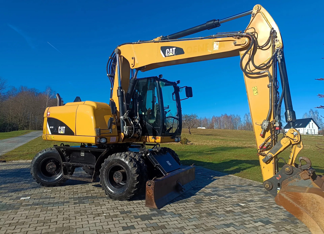 CATERPILLAR M313D - حفار ذو عجلات: صورة 2 CATERPILLAR M313D - حفار ذو عجلات: صورة 2