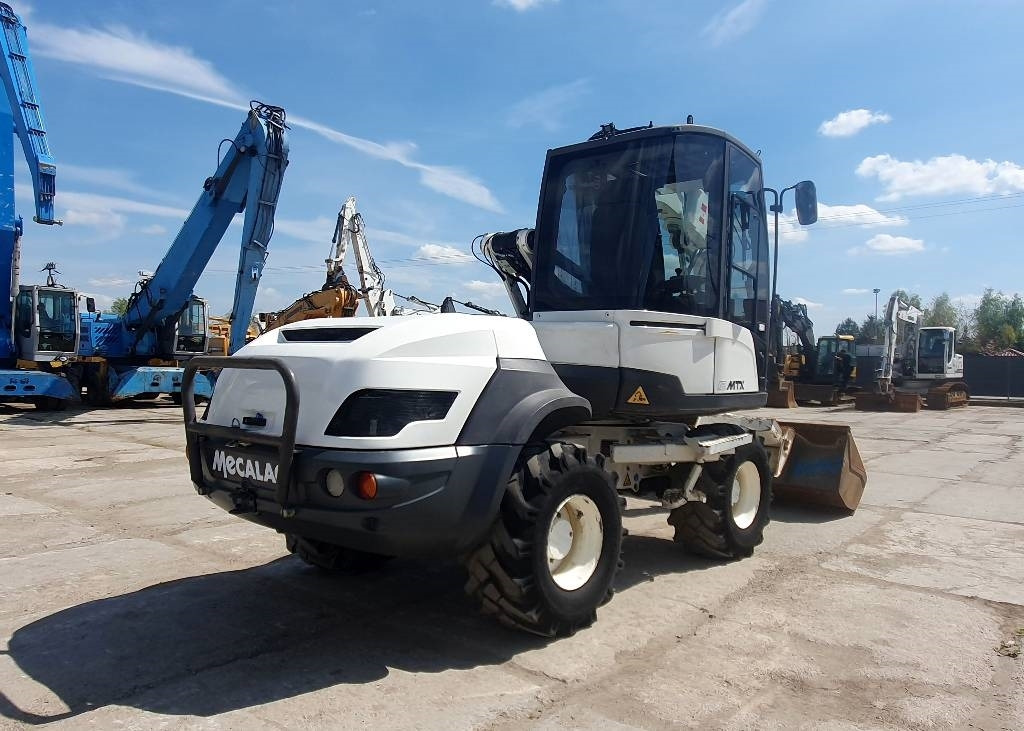 Mecalac 12 M TX - حفار ذو عجلات: صورة 4 Mecalac 12 M TX - حفار ذو عجلات: صورة 4